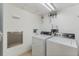 On-site laundry room with washer, dryer, utility sink, and rubbish disposal for residents' convenience at 1 Oceans West Blvd # 6A5, Daytona Beach, FL 32118