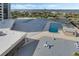 Aerial view of community pool and lounge area with lush landscaping and water views at 1 Oceans West Blvd # 6A5, Daytona Beach, FL 32118