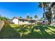 View of the backyard with a well-maintained lawn and mature trees that provide plenty of shade at 1039 Beulah Dr, Edgewater, FL 32132