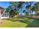 Expansive backyard featuring lush green grass, mature trees, and a wood fence at 1039 Beulah Dr, Edgewater, FL 32132