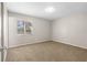 Cozy bedroom featuring neutral walls, plush carpeting, and natural light from a window at 1039 Beulah Dr, Edgewater, FL 32132