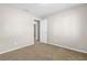 Bedroom showcasing neutral walls, plush carpeting, and an entry door at 1039 Beulah Dr, Edgewater, FL 32132