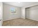 Bright bedroom featuring neutral walls, plush carpeting, natural light, and a closet at 1039 Beulah Dr, Edgewater, FL 32132