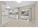 Eat-in kitchen featuring white cabinetry, granite countertops, and tile flooring at 1039 Beulah Dr, Edgewater, FL 32132