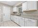 Well-lit kitchen featuring granite countertops, white cabinetry, and stainless steel appliances at 1039 Beulah Dr, Edgewater, FL 32132