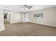 View of carpeted living room with ceiling fan and access to hallway at 1039 Beulah Dr, Edgewater, FL 32132