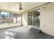 Bright sunroom featuring a ceiling fan, neutral paint, and plenty of natural light through the large windows at 1039 Beulah Dr, Edgewater, FL 32132