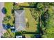 Aerial view of single-Gathering home with fenced backyard, trailer parking, and mature trees in lush green landscape at 1043 Beulah Dr, Edgewater, FL 32132