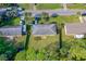 Aerial view of home with fenced yard, mature palms, and green space nestled among neighboring homes at 1043 Beulah Dr, Edgewater, FL 32132