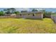 Expansive backyard featuring lush green grass, privacy fence, and access to the house via sliding glass doors at 1043 Beulah Dr, Edgewater, FL 32132
