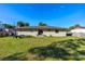 Expansive backyard featuring green grass, a trailer, and privacy fencing at 1043 Beulah Dr, Edgewater, FL 32132