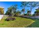 Wide-open, grassy backyard with a trailer in view and a tall wood fence at 1043 Beulah Dr, Edgewater, FL 32132