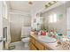 Bathroom featuring a sink, a toilet, and a shower behind a glass door at 1043 Beulah Dr, Edgewater, FL 32132