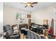 Bedroom with a window, a ceiling fan, and a gray rocking chair at 1043 Beulah Dr, Edgewater, FL 32132