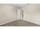 Bedroom with neutral walls and carpet and a white door open to another room at 1043 Beulah Dr, Edgewater, FL 32132