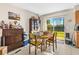 Bright dining area with a view to the backyard through a sliding glass door, plus some boxes at 1043 Beulah Dr, Edgewater, FL 32132