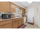 Functional kitchen with wooden cabinets, a double sink, and tiled flooring at 1043 Beulah Dr, Edgewater, FL 32132