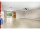 Bright living room featuring tile floors, sliding glass doors to the backyard, and a ceiling fan at 1043 Beulah Dr, Edgewater, FL 32132