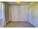 Bedroom showcasing a decorative accent wall, plush carpet, and natural light at 1100 Loch Linnhe Ct, New Smyrna Beach, FL 32168