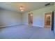 Spacious bedroom showing doorway to a bathroom with a standalone sink at 1100 Loch Linnhe Ct, New Smyrna Beach, FL 32168