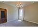 Bedroom with light-filled window, gray carpet, and open doorway to hallway at 1100 Loch Linnhe Ct, New Smyrna Beach, FL 32168