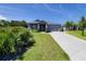 Well maintained single-story home with driveway and manicured lawn at 1100 Loch Linnhe Ct, New Smyrna Beach, FL 32168