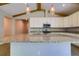 Kitchen island featuring granite counters and pendant lighting, complemented by bright cabinets at 1100 Loch Linnhe Ct, New Smyrna Beach, FL 32168