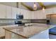 Kitchen featuring granite countertops, stainless steel appliances, and bright cabinets at 1100 Loch Linnhe Ct, New Smyrna Beach, FL 32168