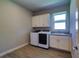 Bright laundry room featuring a washer, dryer, and sink with white cabinets at 1100 Loch Linnhe Ct, New Smyrna Beach, FL 32168