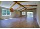 Spacious living room featuring wood-look tile flooring, vaulted ceilings, and natural light at 1100 Loch Linnhe Ct, New Smyrna Beach, FL 32168