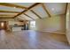 Spacious living room featuring wood-look flooring, vaulted ceiling with wood beams, and an open floor plan at 1100 Loch Linnhe Ct, New Smyrna Beach, FL 32168