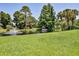 Beautiful community pond with a fountain, gazebo, and lush green surroundings, creating a serene outdoor space at 1100 Loch Linnhe Ct, New Smyrna Beach, FL 32168