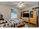 Bedroom with geometric patterned bedspread, flat screen TV, and hardwood floors at 1140 Fairvilla Dr, New Smyrna Beach, FL 32168