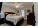 This bedroom features a ceiling fan, a window, and hardwood floor at 1140 Fairvilla Dr, New Smyrna Beach, FL 32168