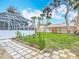 A fenced backyard with a covered, screened-in pool and a small garden at 1175 Margina Ave, Daytona Beach, FL 32114