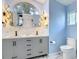 Bathroom with double sinks, decorative mirrors, and a commode at 1175 Margina Ave, Daytona Beach, FL 32114