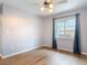 Cozy bedroom featuring hardwood floors, a ceiling fan, and natural light at 1175 Margina Ave, Daytona Beach, FL 32114