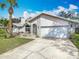 Beautiful home with a well-kept lawn, a spacious driveway, and notable architectural elements at 1175 Margina Ave, Daytona Beach, FL 32114