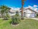 Attractive home with a manicured lawn, mature palm trees, and architectural stone accents at 1175 Margina Ave, Daytona Beach, FL 32114