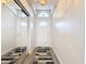 Bright hallway featuring wood floors, a mirrored closet, and a clear view of the home's entrance at 1175 Margina Ave, Daytona Beach, FL 32114