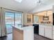 Bright kitchen featuring an island cooktop, skylight, and sliding glass door to the pool at 1175 Margina Ave, Daytona Beach, FL 32114