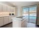 Bright kitchen featuring sleek appliances, a center island with cooktop, and sliding doors to the pool at 1175 Margina Ave, Daytona Beach, FL 32114