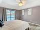 Bright bedroom featuring a ceiling fan, gray walls, and sliding glass doors to the pool area at 1175 Margina Ave, Daytona Beach, FL 32114