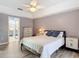 Main bedroom featuring light wood floors, ceiling fan, and view to the bathroom at 1175 Margina Ave, Daytona Beach, FL 32114