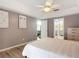 Large bedroom with light gray walls, ceiling fan, and view to both the living room and bathroom at 1175 Margina Ave, Daytona Beach, FL 32114