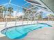 Screened-in pool features a unique shape and a surrounding patio for lounging at 1175 Margina Ave, Daytona Beach, FL 32114