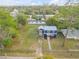 Aerial view of blue two-story home with spacious yard and detached garage at 118 E Palm Way, Edgewater, FL 32132