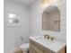 Well-lit bathroom with shiplap walls, tiled shower, and a unique gold-framed mirror at 118 E Palm Way, Edgewater, FL 32132