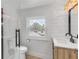 Bright bathroom with shiplap walls, modern fixtures, and a window offering natural light at 118 E Palm Way, Edgewater, FL 32132