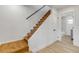 Hallway with wooden stairs leading to the second floor and a white shiplap wall at 118 E Palm Way, Edgewater, FL 32132